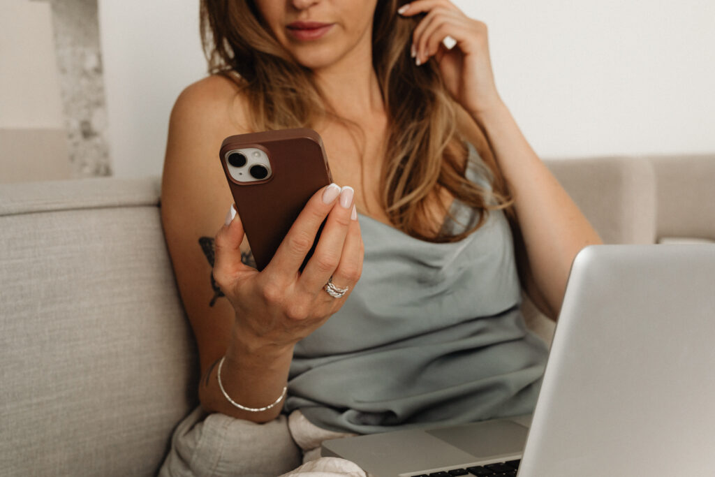 woman looking at her phone for how to create a health coach services page